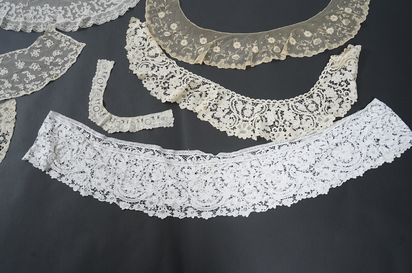 Seven late 19th century collars and trimming, being a long wide length of bobbin lace trimming - 268cm, two similar Bruges cream lace collars, an Irish Carrick-ma-cross collar, a fine needle run collar and another with a